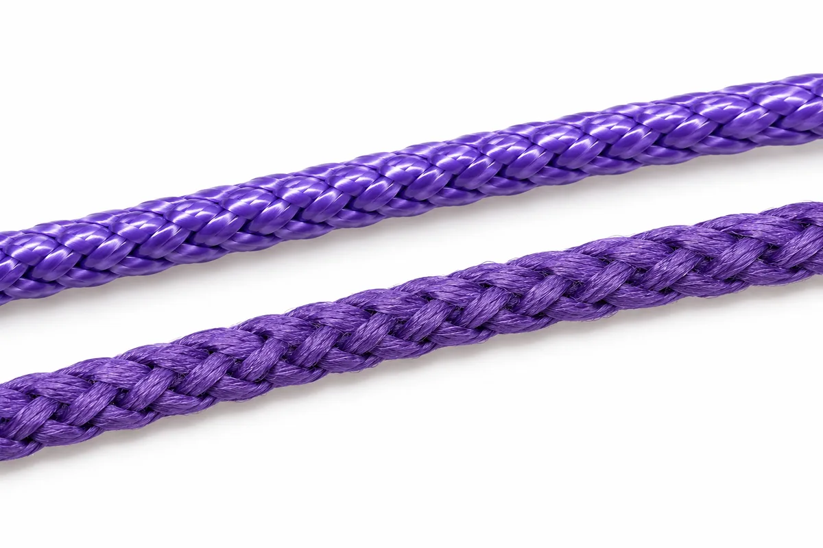 Two braided sutures side by side, one with a smooth glossy coating and one uncoated and matte.