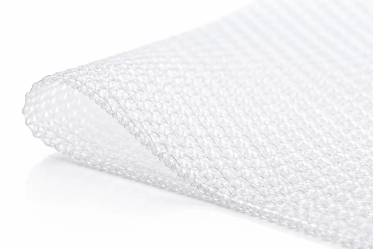 A sheet of knitted polypropylene surgical mesh, showing the knit loops and the open pores between them.